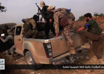 This image posted on the Twitter page of Syria's al-Qaida-linked Nusra Front on Wednesday, June 15, 2016, which is consistent with AP reporting, shows Nusra Front fighters on their vehicle preparing to leave and battle against Syrian troops and pro-government gunmen, at the hilltop of Khalsa village, southern Aleppo, Syria. Activists reported intense fighting between government troops and rebels in southern Aleppo where the insurgent groups are angling for a strategic hill to expand their presence in the area. The Britain-based Syrian Observatory for Human Rights said the government repelled a rebel advance in the area amid intense air raids. Arabic, bottom right, reads, "departure of the support units to the southern hill of Khalsa." (Al-Nusra Front Twitter page via AP)