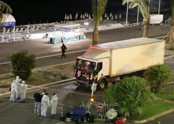 Authorities respond after a truck drove onto a sidewalk for more than a mile, plowing through Bastille Day revelers who'd gathered to watch fireworks in the French resort city of Nice, France, Thursday, July 14, 2016. Officials and eyewitnesses described as a deliberate attack. There appeared to be many casualties. (Sasha Goldsmith via AP)